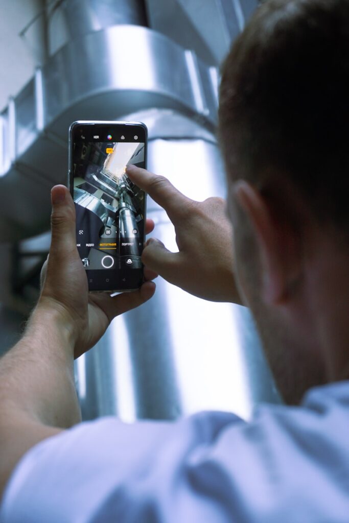 person holding black iphone 4